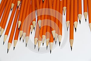 Many black lead pencils on a white background