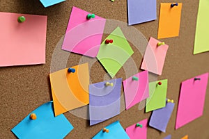 Many blank colorful notes pinned to corkboard