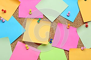 Many blank colorful notes pinned to corkboard. Space for text