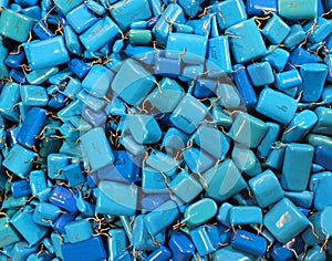 Many blue capacitors as electronics background