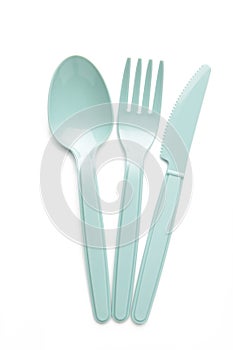 Many blue plasic forks, spoons and knives isolated on white background