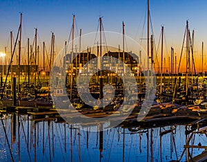 Many boats in the harbor of blankenberge at sunset, beautiful scenery in a popular Belgian city