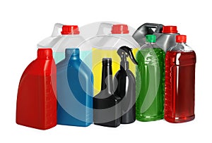Many bottles and canisters with liquids on white background