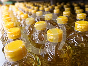 many bottles in row stack of vegetable oil on the shelves in supermarket material for making the healthy food for good health