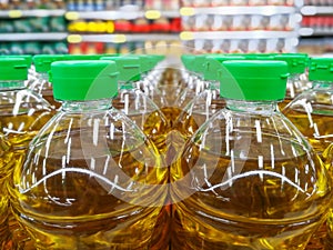 many bottles in row stack of vegetable oil on the shelves in supermarket material for making the healthy food for good health