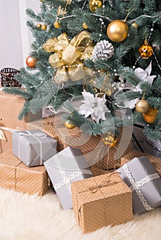 Many boxes with Christmas gifts under the Christmas tree