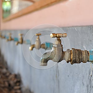 Many brasses water-tap in sink photo