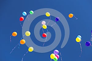 Many bright baloons in the blue sky