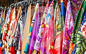 Many bright silk neckerchiefs on the store rack