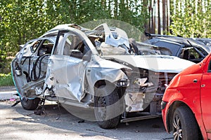 Many broken cars after a traffic accident in the parking lot of a restoration service station on the street. Car body damage