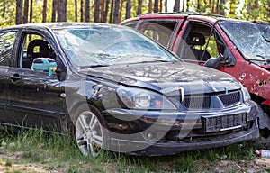 Many broken cars after a traffic accident in the parking lot of a restoration service station on the street. Car body damage