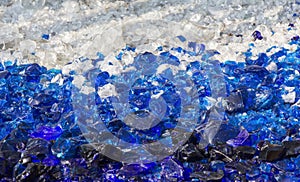 Many broken pieces of glass in white and blue as background