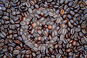 Many brown roasted coffee beans background
