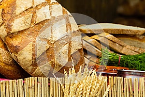 Many brown rustic fresh rye bread loaves