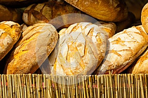 Many brown rustic fresh rye bread loaves