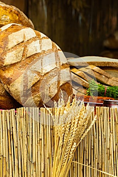 Many brown rustic fresh rye bread loaves