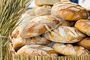 Many brown rustic fresh rye bread loaves