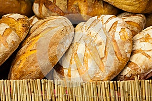 Many brown rustic fresh rye bread loaves