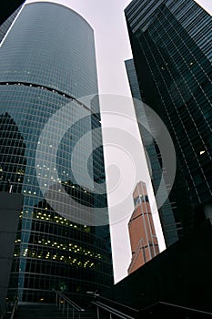 Many buildings of the Moscow business center, from the bottom to the top, diced green stand under a white sky