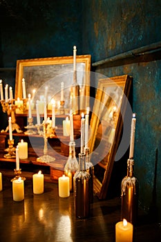 Many burning candles on a mirrored background