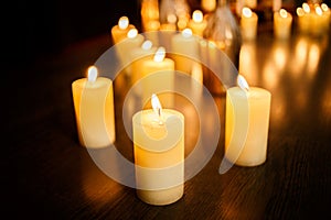 Many burning candles on a mirrored background