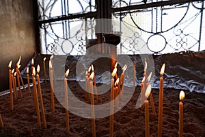 Many burning wax candles in the Saint George`s chapel, Mount Lycabettus, Athens, Greece.