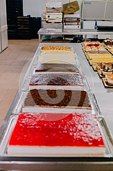 Many cakes prepared on the metal table of a food factory