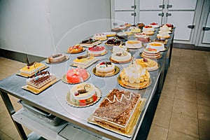 Many cakes prepared on the metal table of a food factory