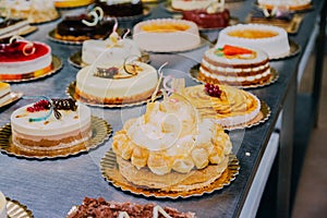 Many cakes prepared on the metal table of a food factory