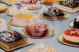 Many cakes prepared on the metal table of a food factory
