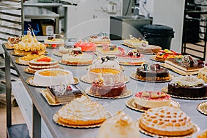 Many cakes prepared on the metal table of a food factory