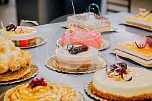 Many cakes prepared on the metal table of a food factory