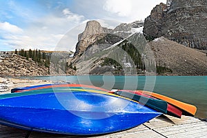 Many Canoes on wooden deck at Moraine lake in Banff national park