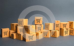 Many cardboard boxeswith drawing of shopping carts. products, goods, Warehouse, stock. commerce and retail. E-commerce, sale