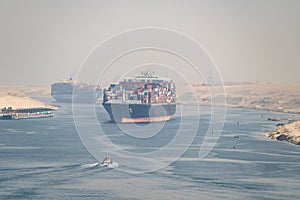 Many cargo ships navigate through Suez Canal. Shipping canal in Egypt. Concept of transportation and logistics