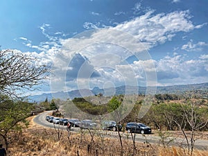 Many cars parked on the side of the road,