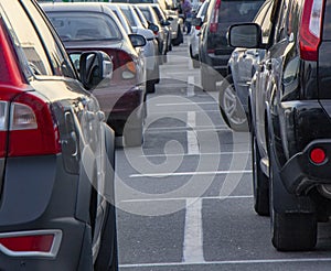 Many cars in the parking lot near the mall