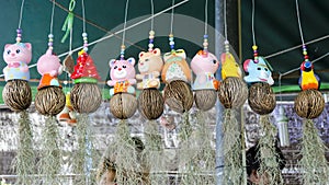 Many ceramic doll hanging containing spanish moss (Tillandsia us