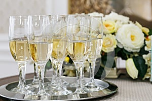 Many of the champagne glasses on the table