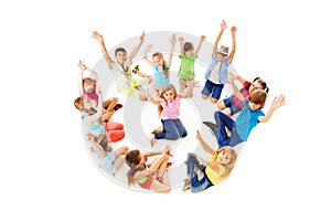 Many children in circle with boy center lift hands