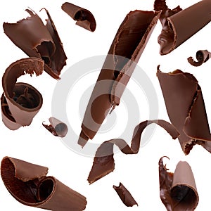 Many chocolate curls falling on white background