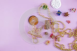 MANY CHRISTMAS ORNAMENTS. DECORATIVE ELEMENTS ON PINK BACKGROUND