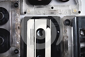 Many classic audio cassette tape with magnetic tape inside. Retro background