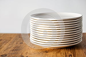 Many Clean white plates dishes kitchenwear on table