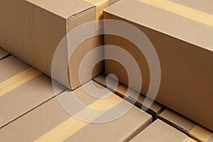 Many closed cardboard boxes as background. Packaging goods