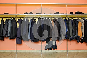 Many clothes in cloakroom photo