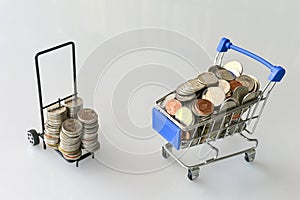 Many coins in the blue shopping cart Isolated on white background and copy space, saving and investment concept