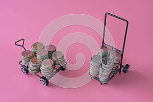 Many coins in the two shopping carts Isolated on pink background and copy space, saving and investment concept