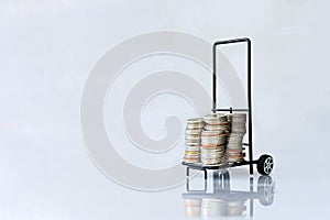 Many coins in the two shopping carts Isolated on white background and copy space, saving and investment concept