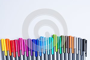 Many color fine liners in line on white background